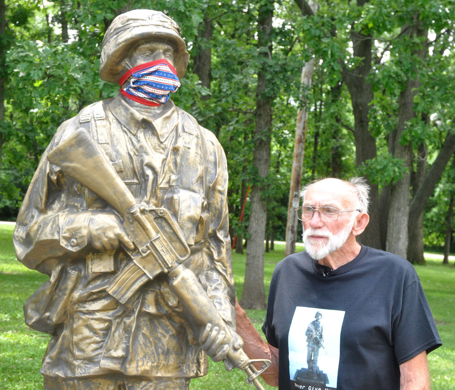 Richard Olenoski looks over a military statue that he and other Bloomfield residents help bring
